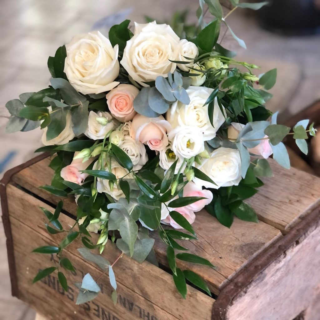 White and blush rose bouquet on wooden box