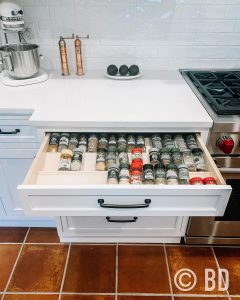Tiered spice drawer in kitchen