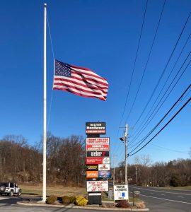 milton hardware road sign and american flag