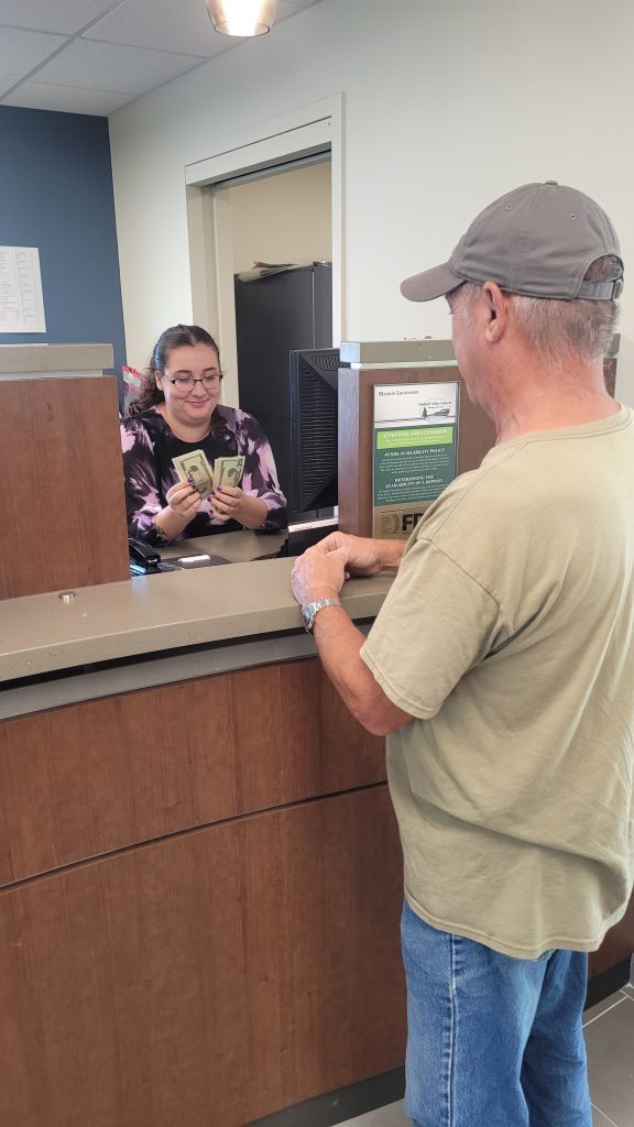 teller counting money to customer